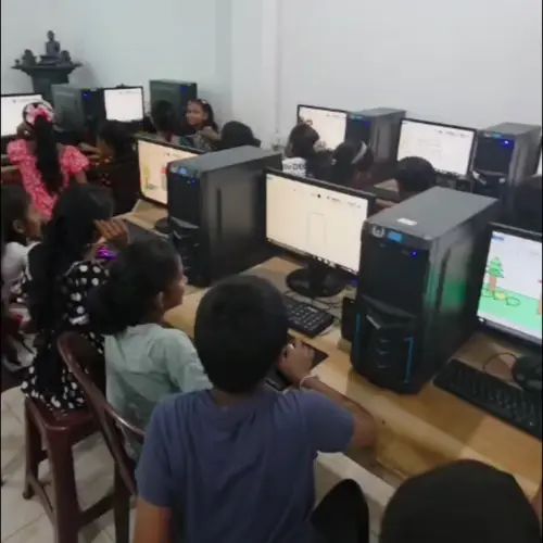 SICTA computer laboratory with students working at desktop computers